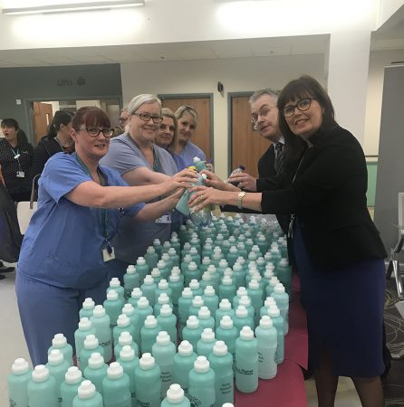 Tameside Hospital staff handing over eco-friendly water bottles