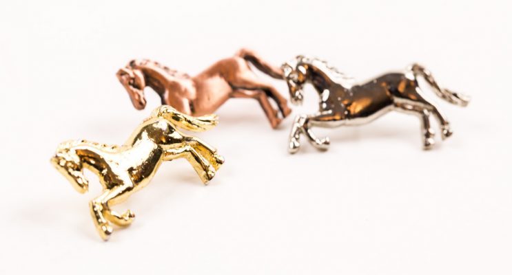 Three metal horse shaped badges