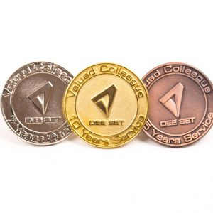 three award badges in gold, silver and nickel