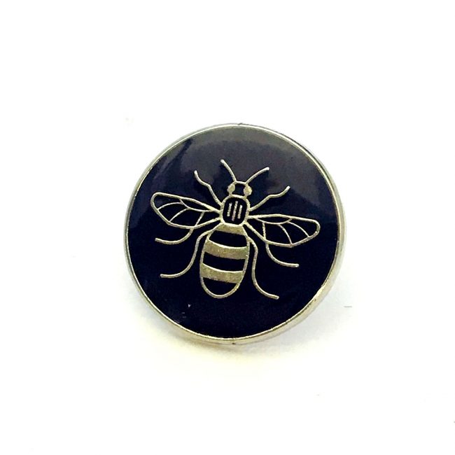 Black badge with Manchester bee