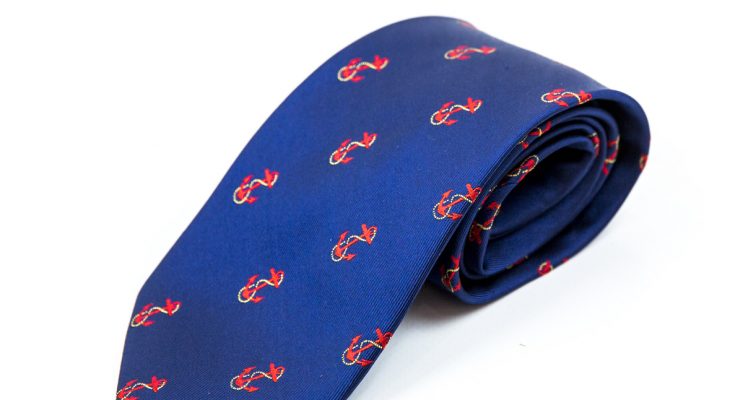 Blue rolled tie with orange anchor embroidery logo