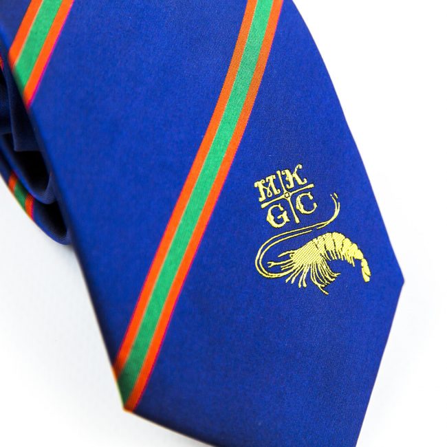 Close up of blue tie with gold embroidered logo