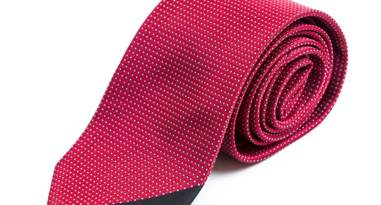 Red tie rolled up with white dots