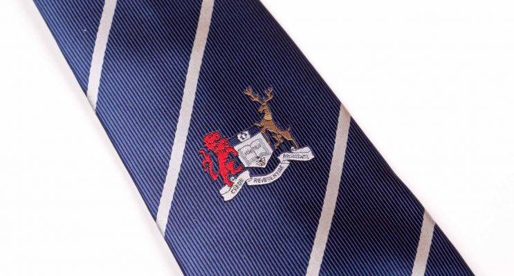 Dark blue tie with white stripes and embroidered logo