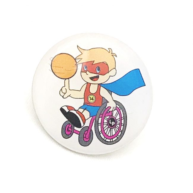 Printed badge with image of boy in superhero costume on wheelchair