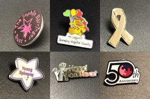Group of metal charity badges