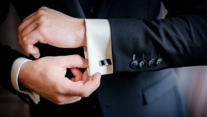 Man putting on cufflinks for black tie event