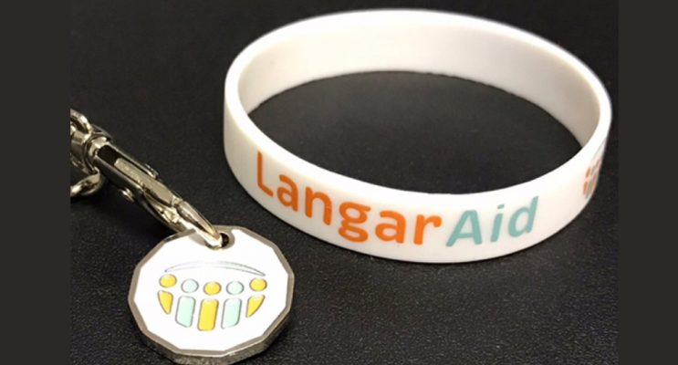 Langar Aid charity wristband and trolley coin with logo