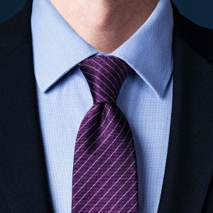 Simple purple knot tie with blue shirt 