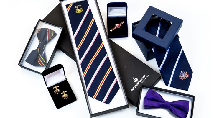 Group of corporate merchandise including matching ties, cufflinks and gift box