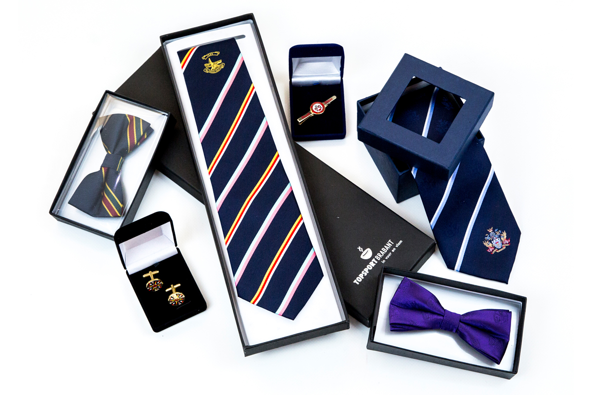 Group of corporate merchandise including matching ties, cufflinks and gift box