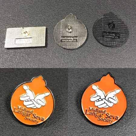 Three custom pin badges that show the  difference between nickel, black nickel & dye black finishes